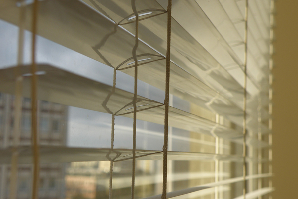 close up of a venetian blind in a window
